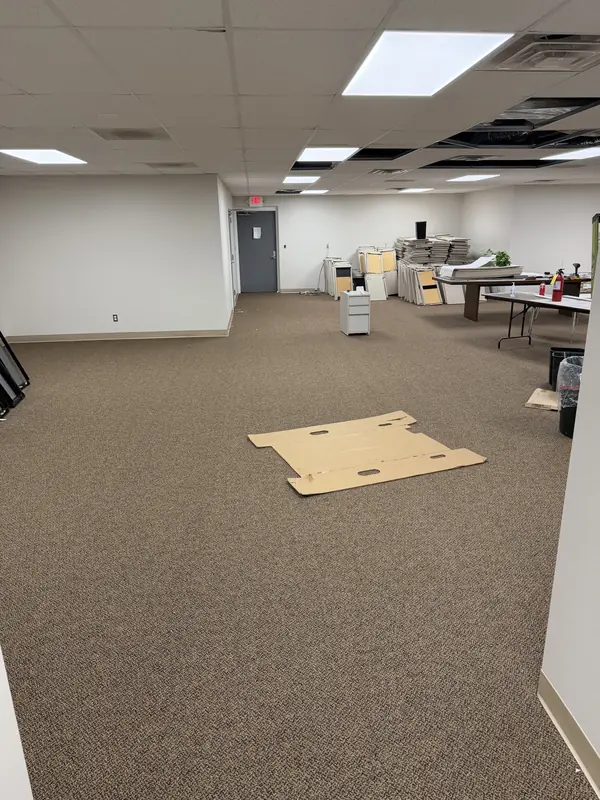 Commercial carpet installation in progress in a large office space